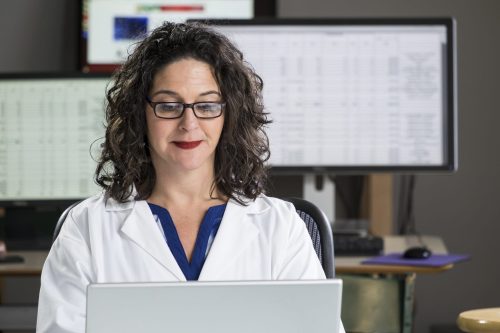 Health professional entering data into computer